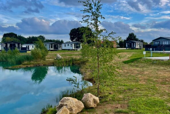 Lakeside lodges ranged around the still water of the private fishing lake at Derwent Oaks